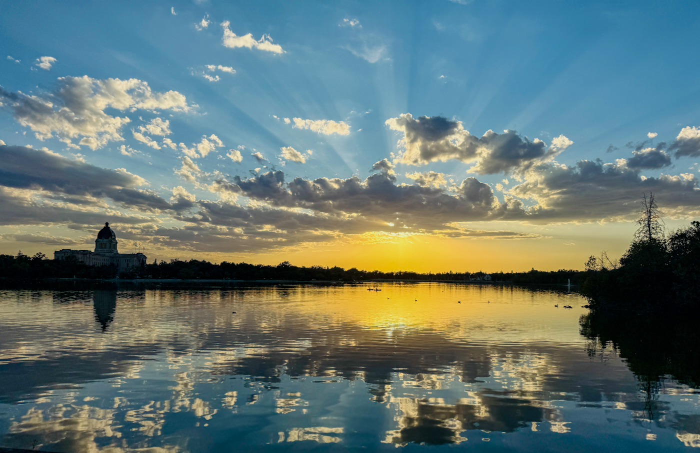 Wascana Lake at sunset with orange sun